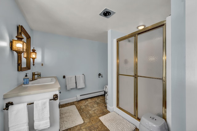 bathroom featuring a shower with door, vanity, and baseboard heating