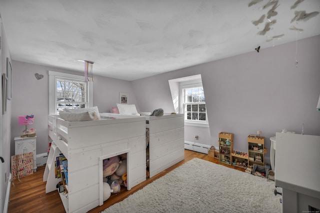 bedroom featuring multiple windows, hardwood / wood-style floors, and a baseboard radiator