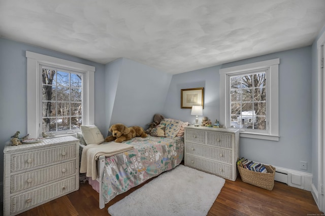 bedroom with dark hardwood / wood-style flooring