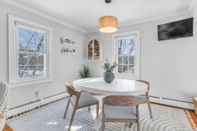 dining area featuring a baseboard radiator and ornamental molding