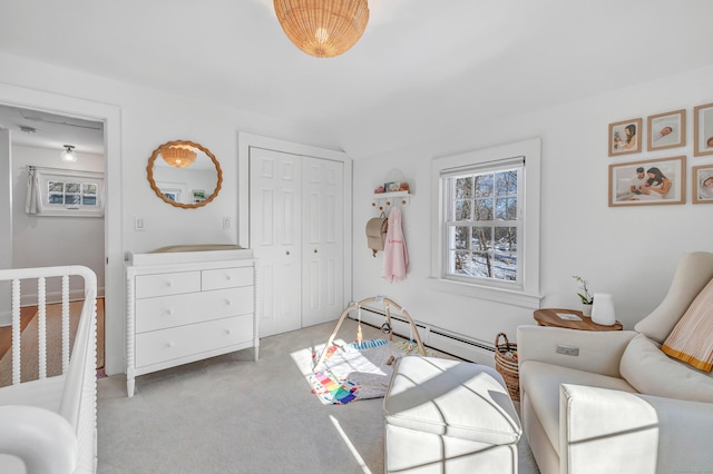 bedroom featuring a baseboard radiator, lofted ceiling, light colored carpet, and a closet