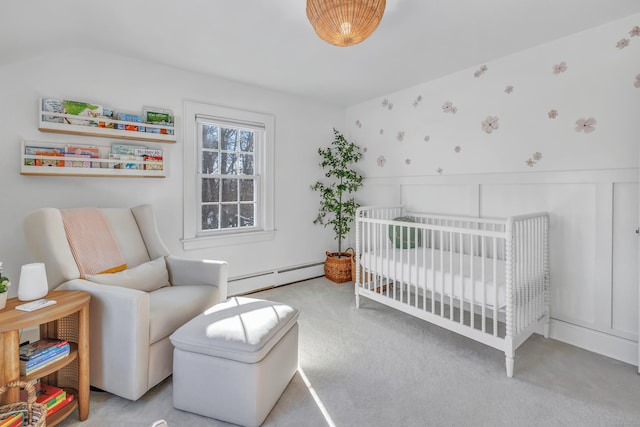 bedroom featuring a baseboard heating unit, light colored carpet, and a nursery area