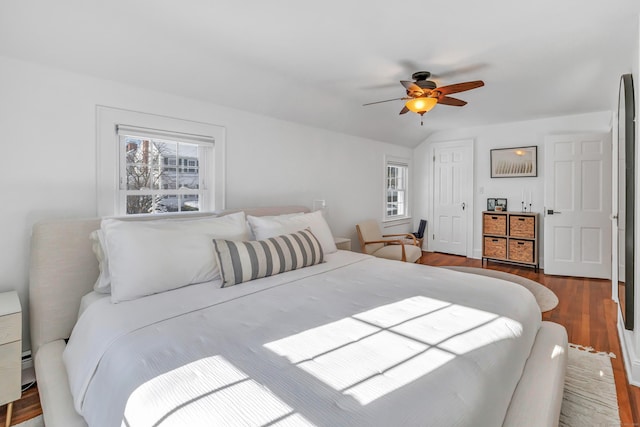 bedroom with ceiling fan, lofted ceiling, and hardwood / wood-style floors