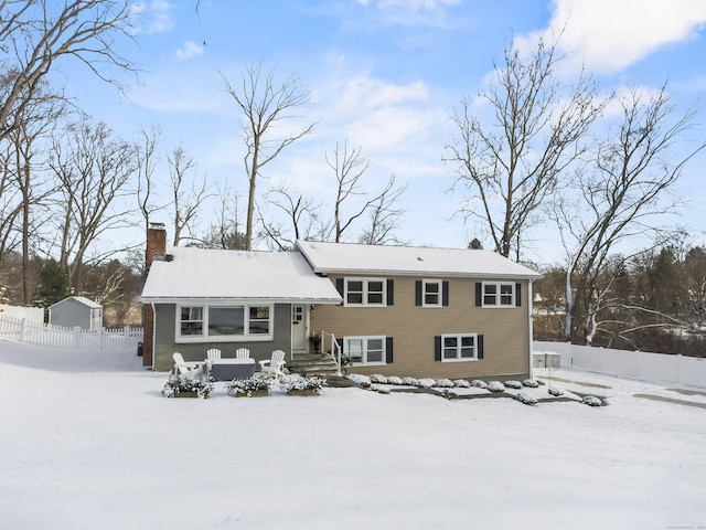 view of snow covered rear of property