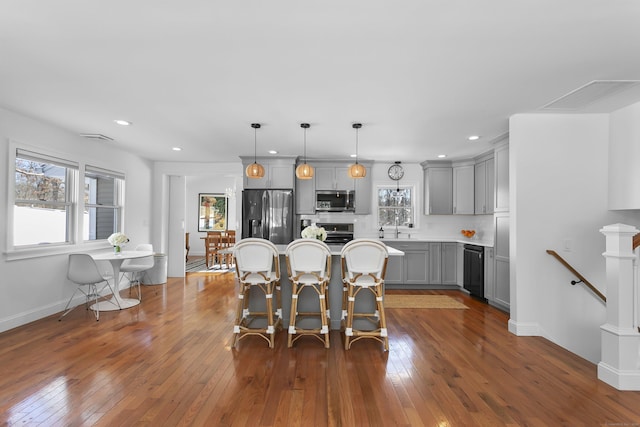 dining space with sink and dark wood-type flooring