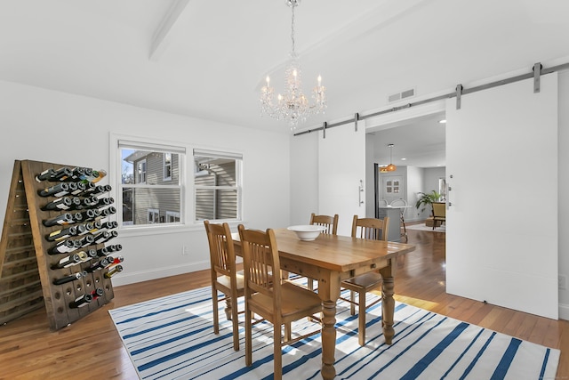 dining area featuring hardwood / wood-style floors and a barn door