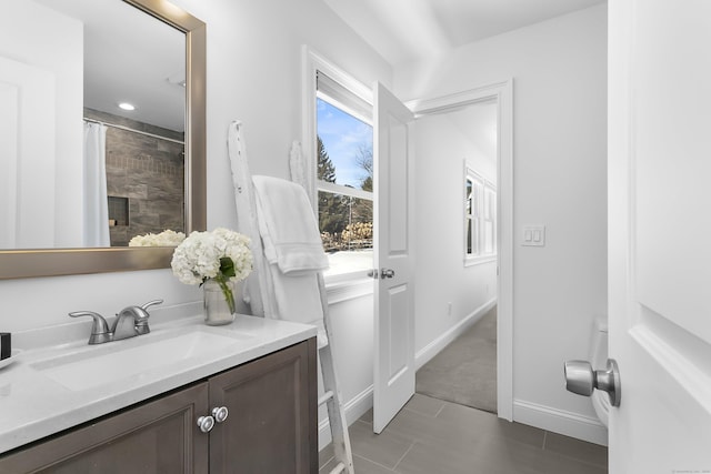 bathroom featuring tile patterned flooring, vanity, and curtained shower