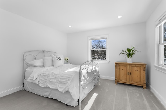 carpeted bedroom featuring multiple windows