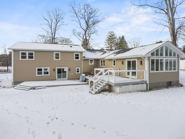 snow covered property featuring a deck