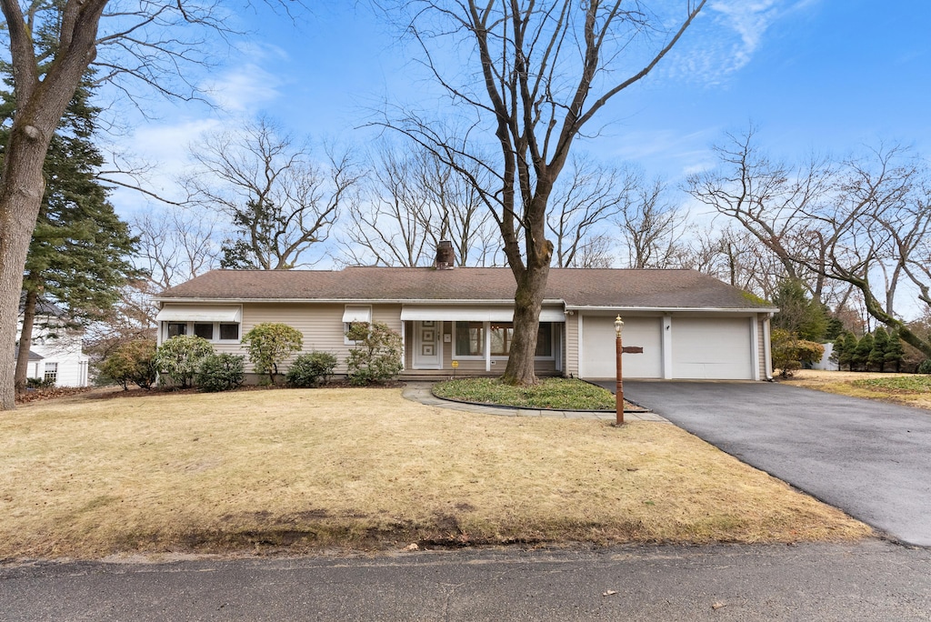 ranch-style home with a front yard and a garage