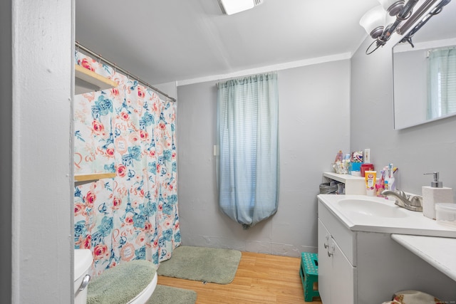 bathroom with toilet, wood-type flooring, ornamental molding, a shower with shower curtain, and vanity