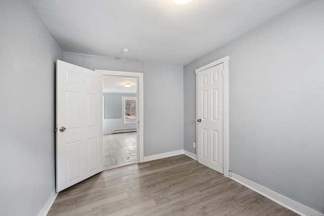 interior space with a baseboard radiator and light wood-type flooring