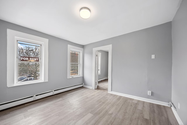 interior space featuring a baseboard radiator and light hardwood / wood-style flooring