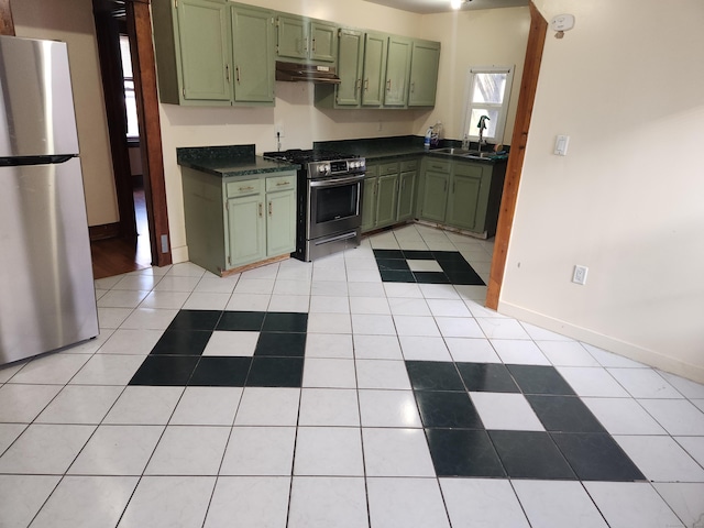 kitchen with sink, appliances with stainless steel finishes, green cabinetry, and light tile patterned flooring