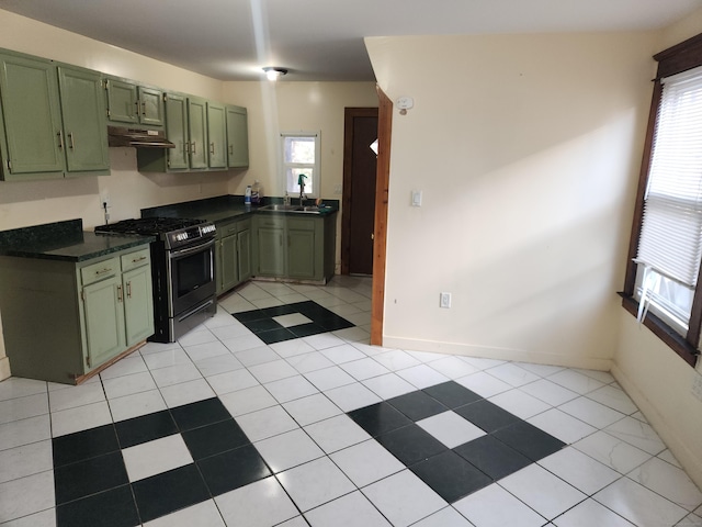 kitchen with sink, stainless steel range with gas stovetop, green cabinetry, and light tile patterned flooring