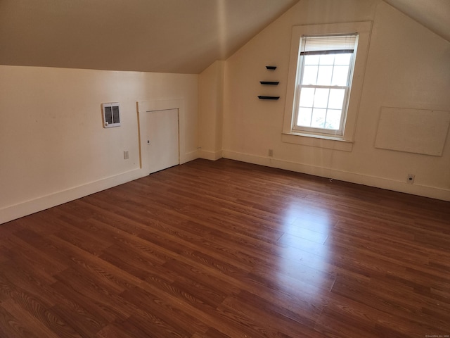 bonus room with lofted ceiling and dark hardwood / wood-style floors