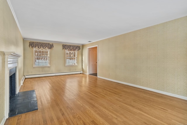 unfurnished living room with hardwood / wood-style flooring, ornamental molding, and a baseboard heating unit