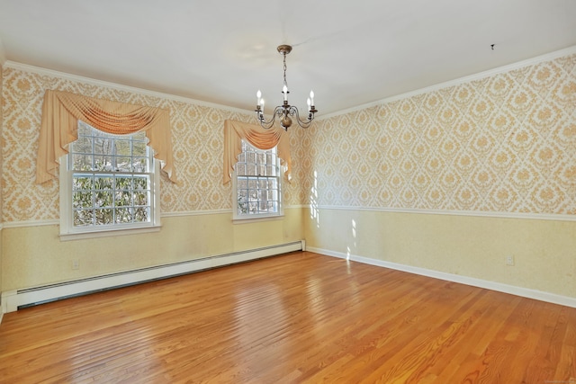 unfurnished room with hardwood / wood-style flooring, ornamental molding, a baseboard heating unit, and a chandelier