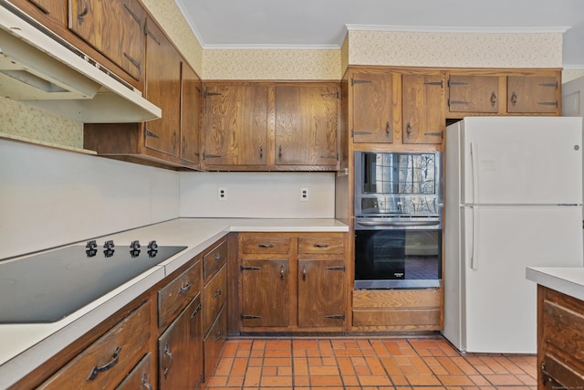 kitchen featuring double oven, black electric stovetop, ornamental molding, and white refrigerator