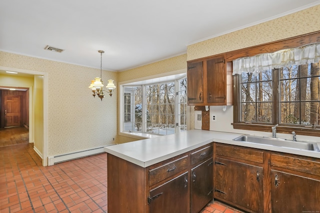 kitchen with sink, hanging light fixtures, baseboard heating, kitchen peninsula, and an inviting chandelier