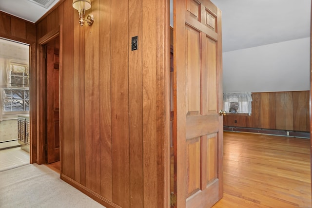 corridor featuring wooden walls