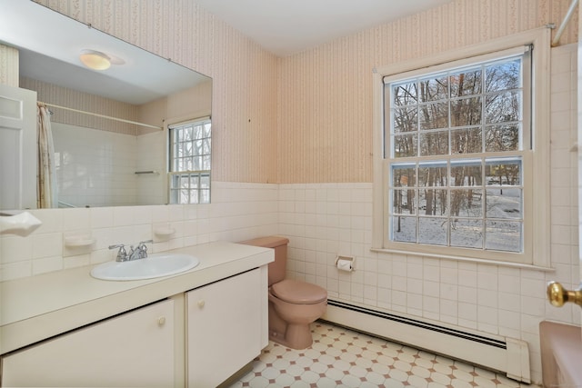 bathroom featuring tile walls, vanity, a baseboard heating unit, toilet, and a shower with curtain