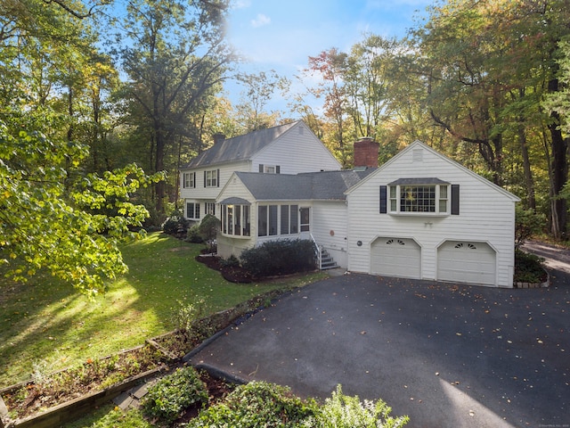 view of front of home featuring a garage and a front yard