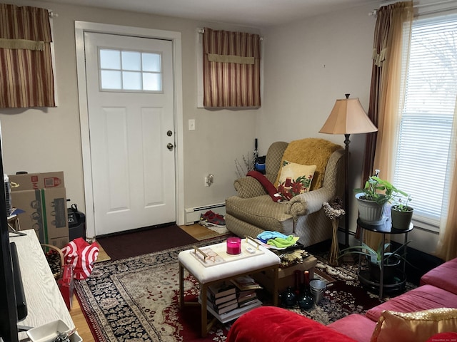 living room with wood-type flooring and a baseboard heating unit