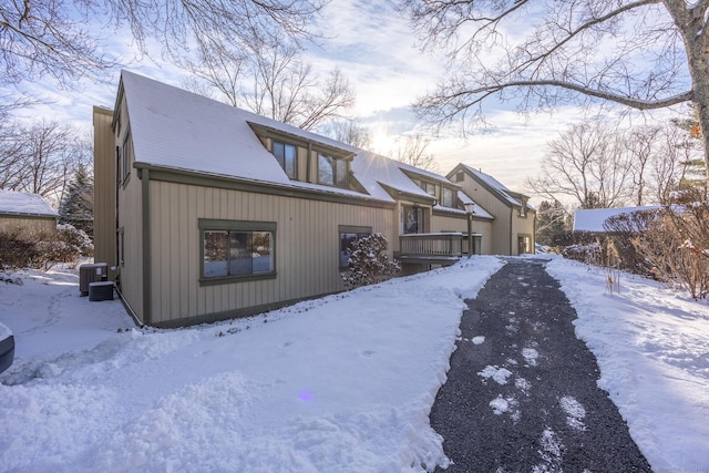 snow covered property featuring central AC