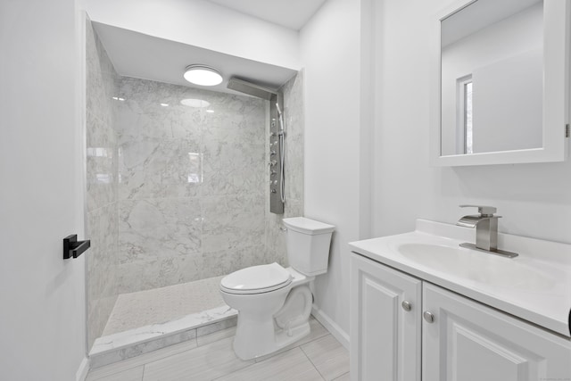 bathroom with tiled shower, toilet, tile patterned floors, and vanity