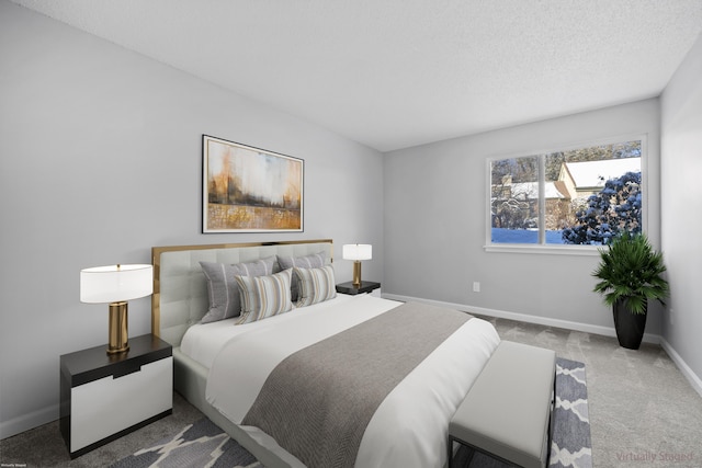 bedroom with a textured ceiling and carpet floors