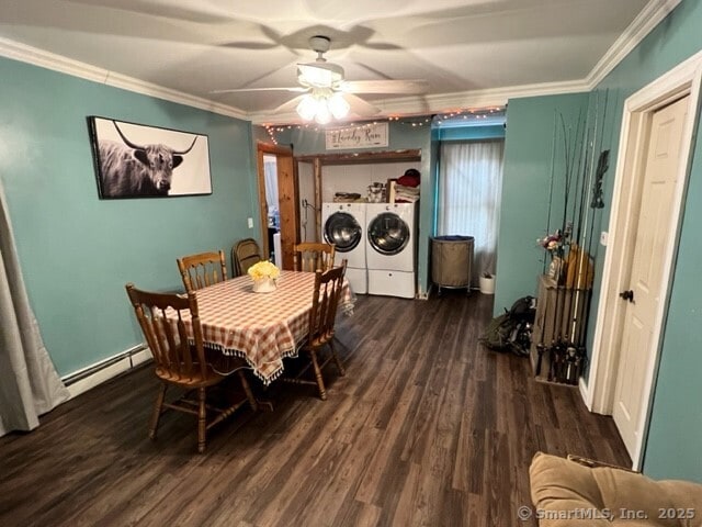 dining space with baseboard heating, dark wood-type flooring, ornamental molding, independent washer and dryer, and ceiling fan