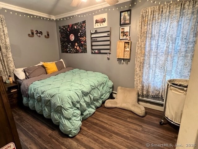 bedroom featuring crown molding, dark hardwood / wood-style floors, and vaulted ceiling