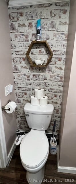 bathroom featuring wood-type flooring and toilet