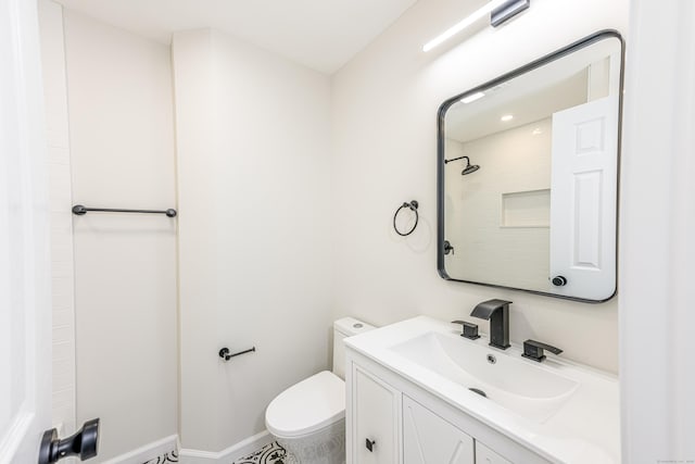 bathroom with vanity, toilet, and walk in shower