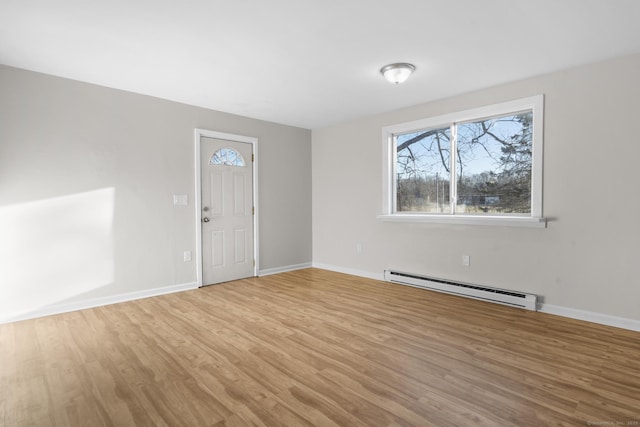 foyer featuring light wood-type flooring and baseboard heating