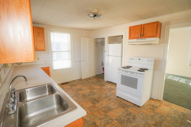 kitchen featuring white appliances, sink, and dark colored carpet