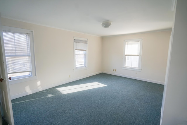 carpeted spare room with crown molding