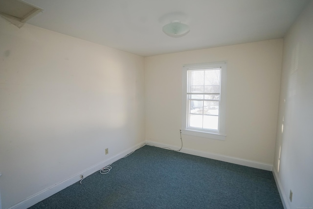 unfurnished room with dark carpet