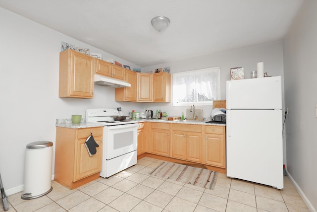 kitchen featuring white appliances, light brown cabinets, a sink, light countertops, and under cabinet range hood