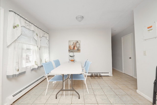 dining area with light tile patterned floors, baseboards, and baseboard heating