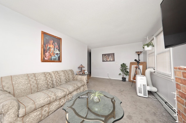 carpeted living room featuring a baseboard heating unit and baseboards