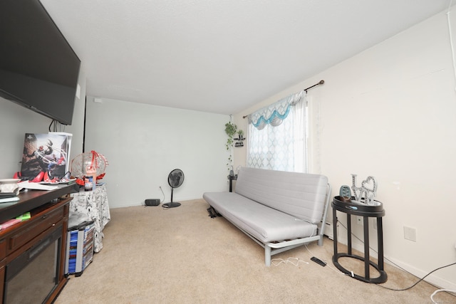 sitting room featuring baseboards and carpet flooring