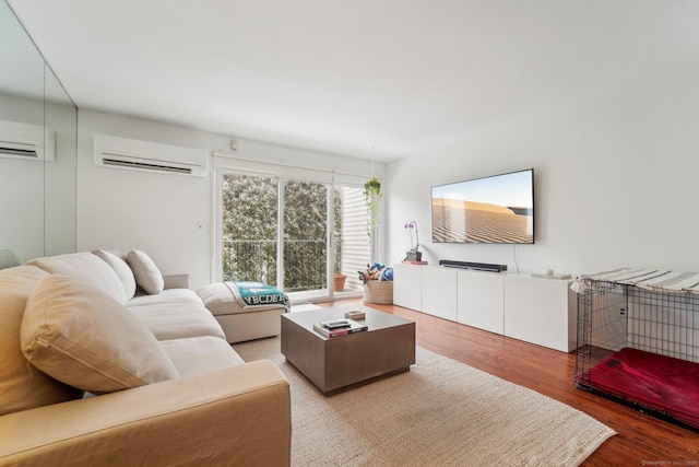 living room with a wall mounted air conditioner and hardwood / wood-style flooring