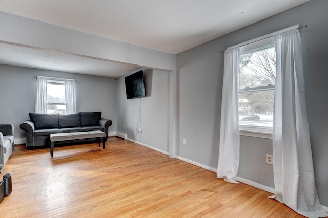 living area featuring a textured ceiling and light wood-type flooring