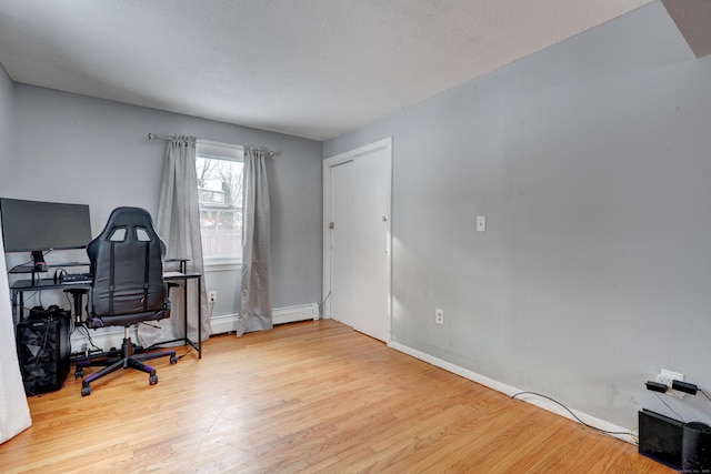 office area featuring light hardwood / wood-style floors and a textured ceiling