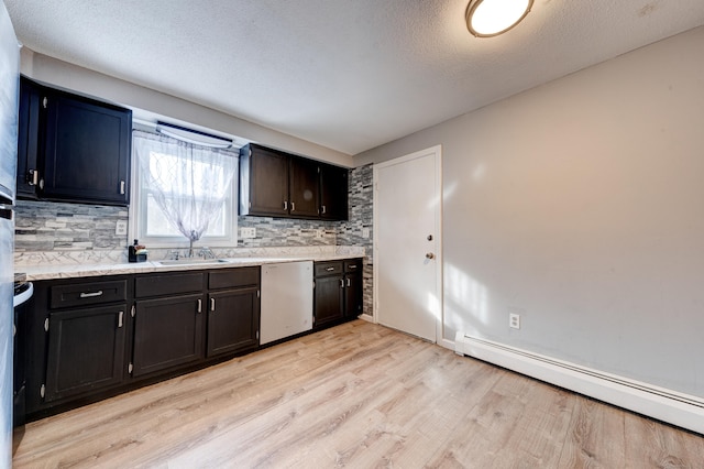 kitchen with tasteful backsplash, sink, stainless steel dishwasher, baseboard heating, and light wood-type flooring