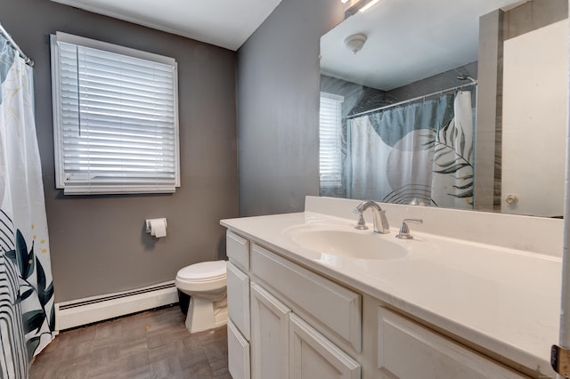 bathroom with vanity, a baseboard radiator, and toilet