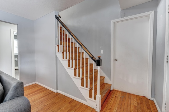 staircase featuring wood-type flooring