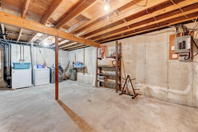 basement featuring electric panel and washer and dryer